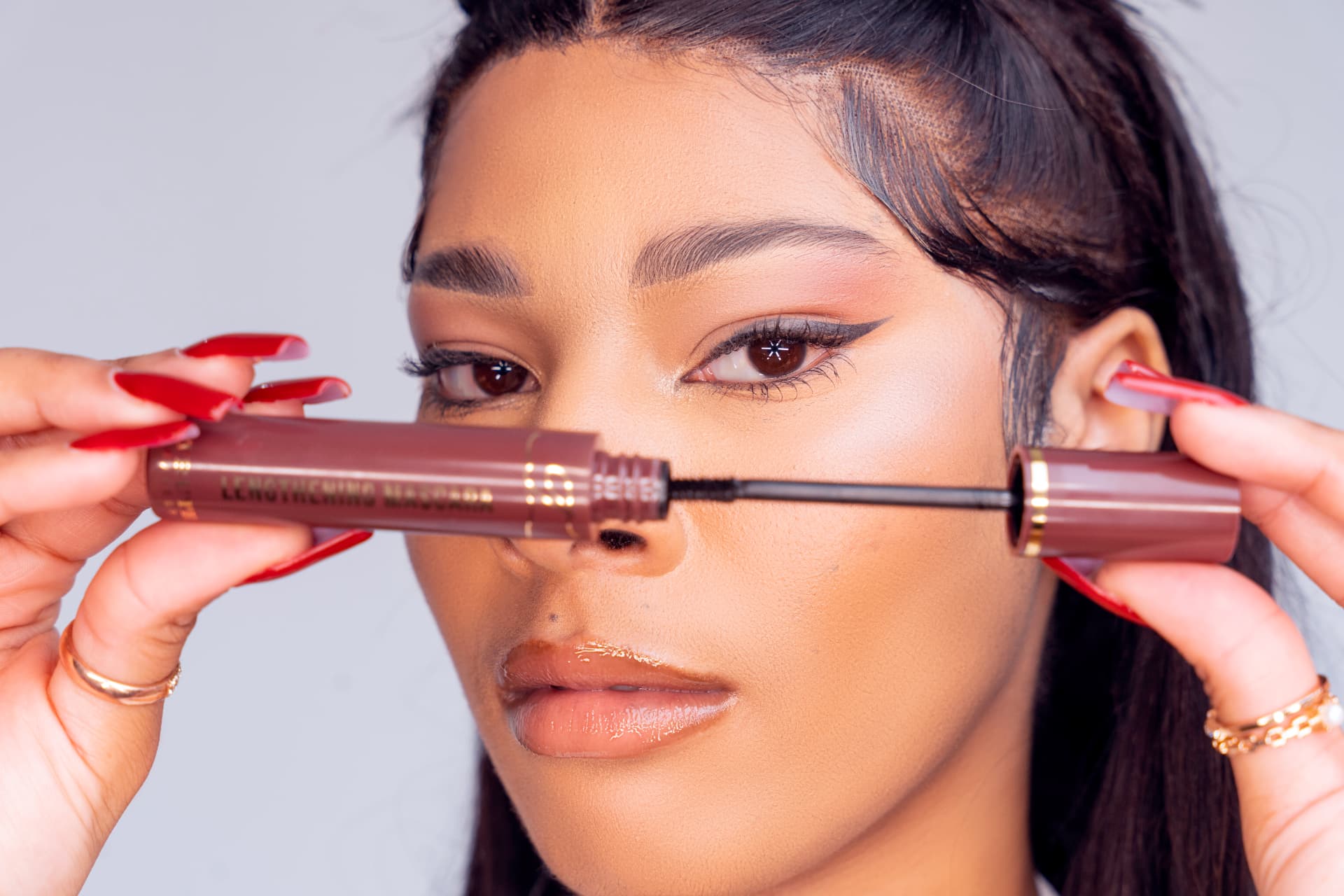 Model holding a lengthening mascara
