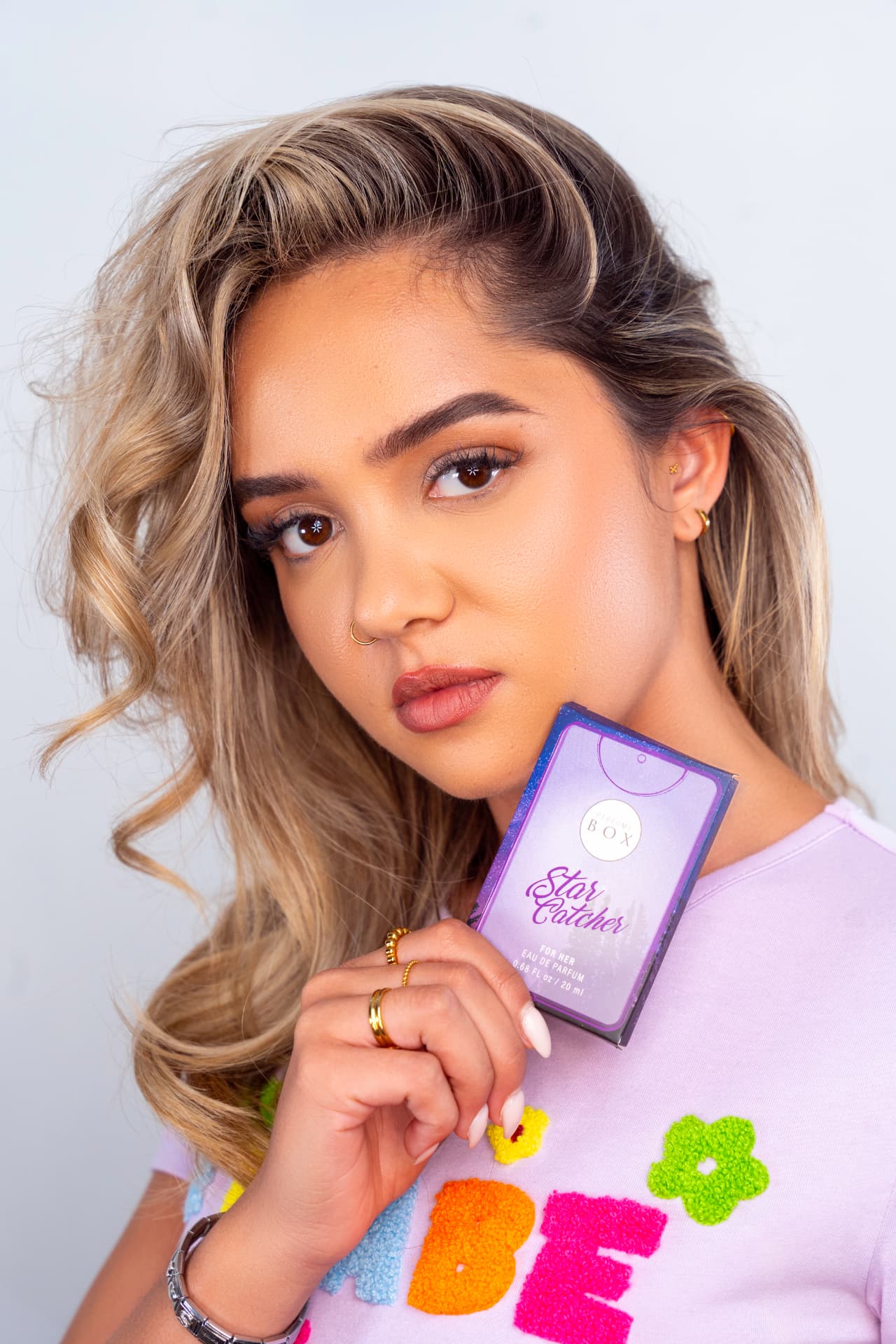 Model holding a Star Catcher pocket perfume by Perfume Box